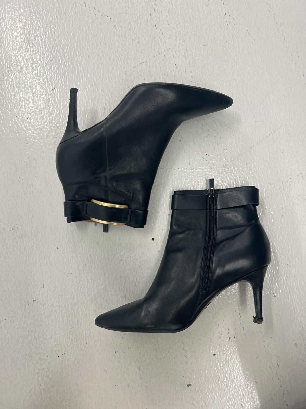 Chic Black Leather Ankle Boots with Gold Accent