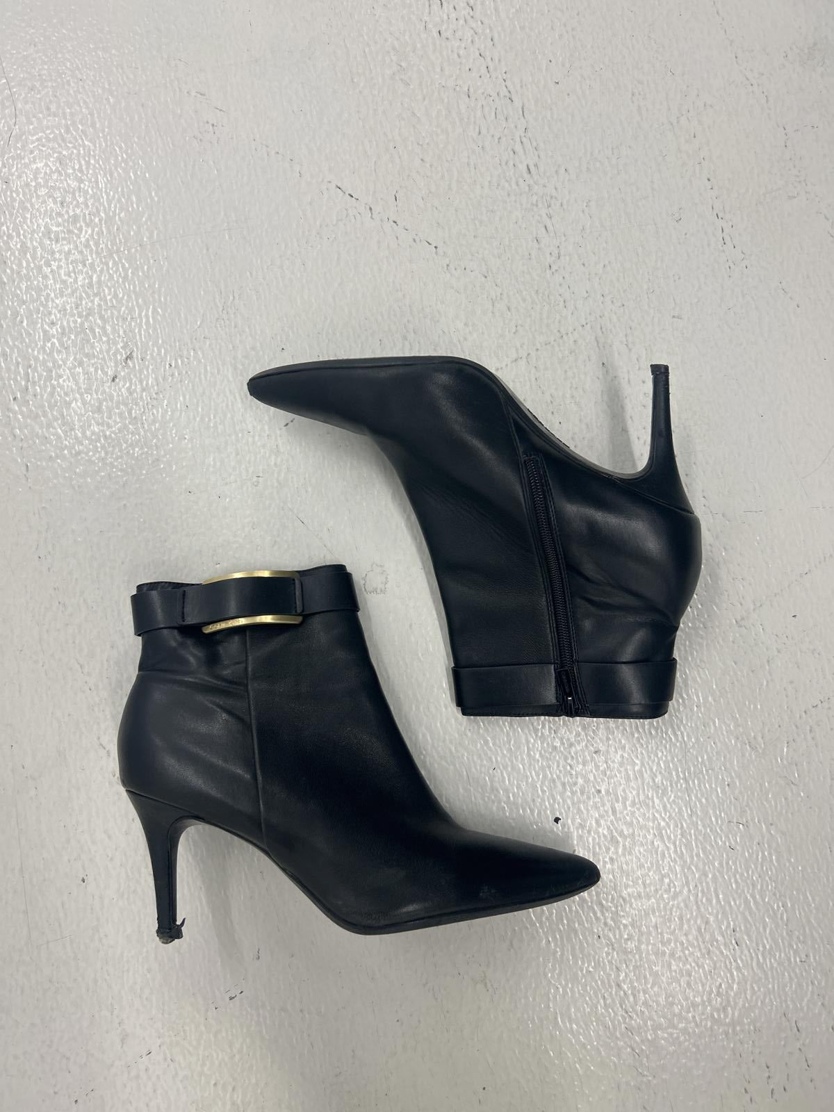 Chic Black Leather Ankle Boots with Gold Accent